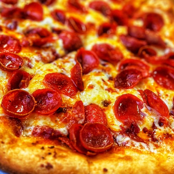 Close-up of a freshly baked pepperoni pizza with melted cheese and crispy crust.