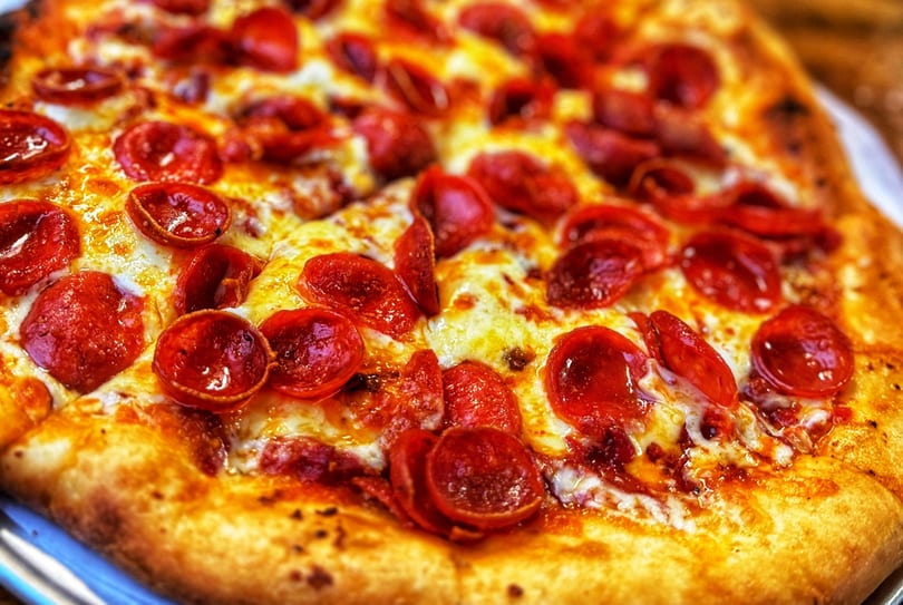 Close-up of a freshly baked pepperoni pizza with melted cheese and crispy crust.
